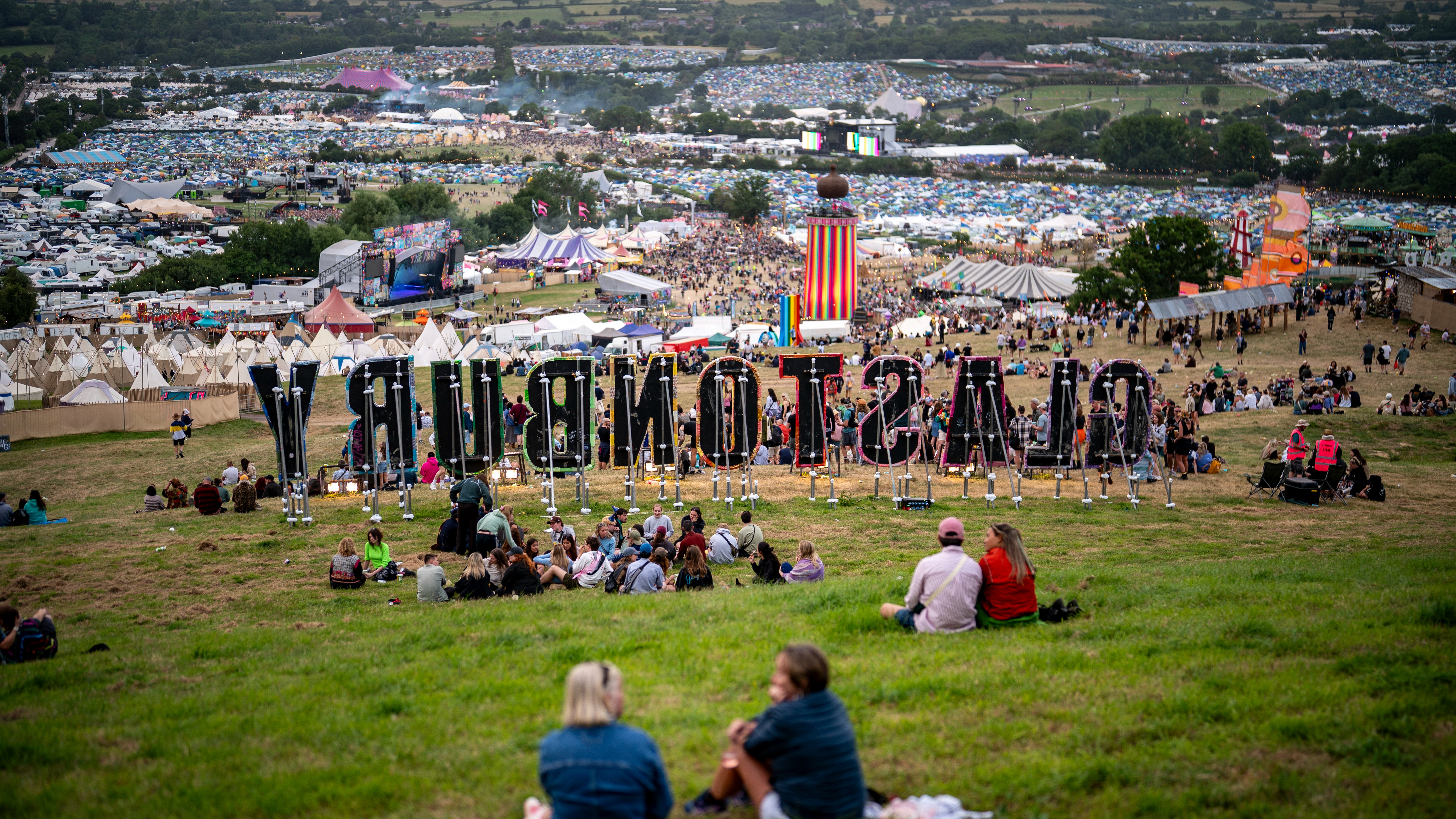 Festival-goers on the fields of Worthy Farm during Glastonbury Festival, Somerset